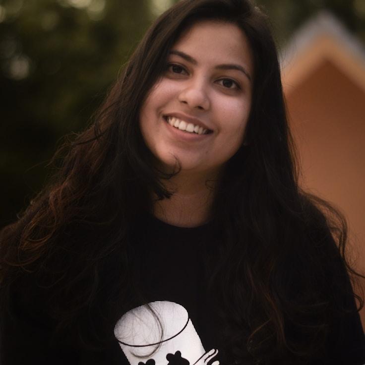 Kaveri Mehta, Lead Design Curator at CopperLatticePond, reviewing corporate floral arrangements